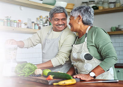 A married couple making a smoothie together
